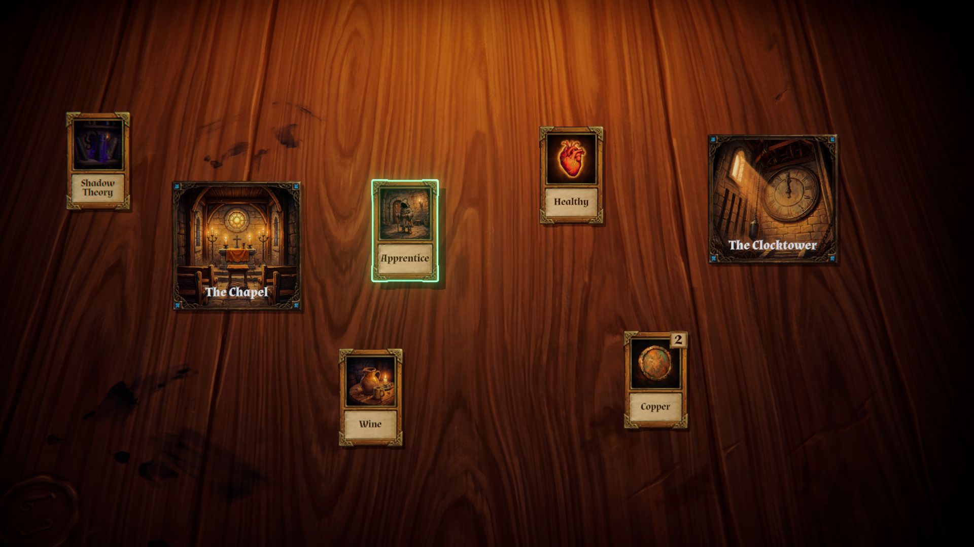 The Chapel, the Clocktower and the Apprentice card on a wooden table
